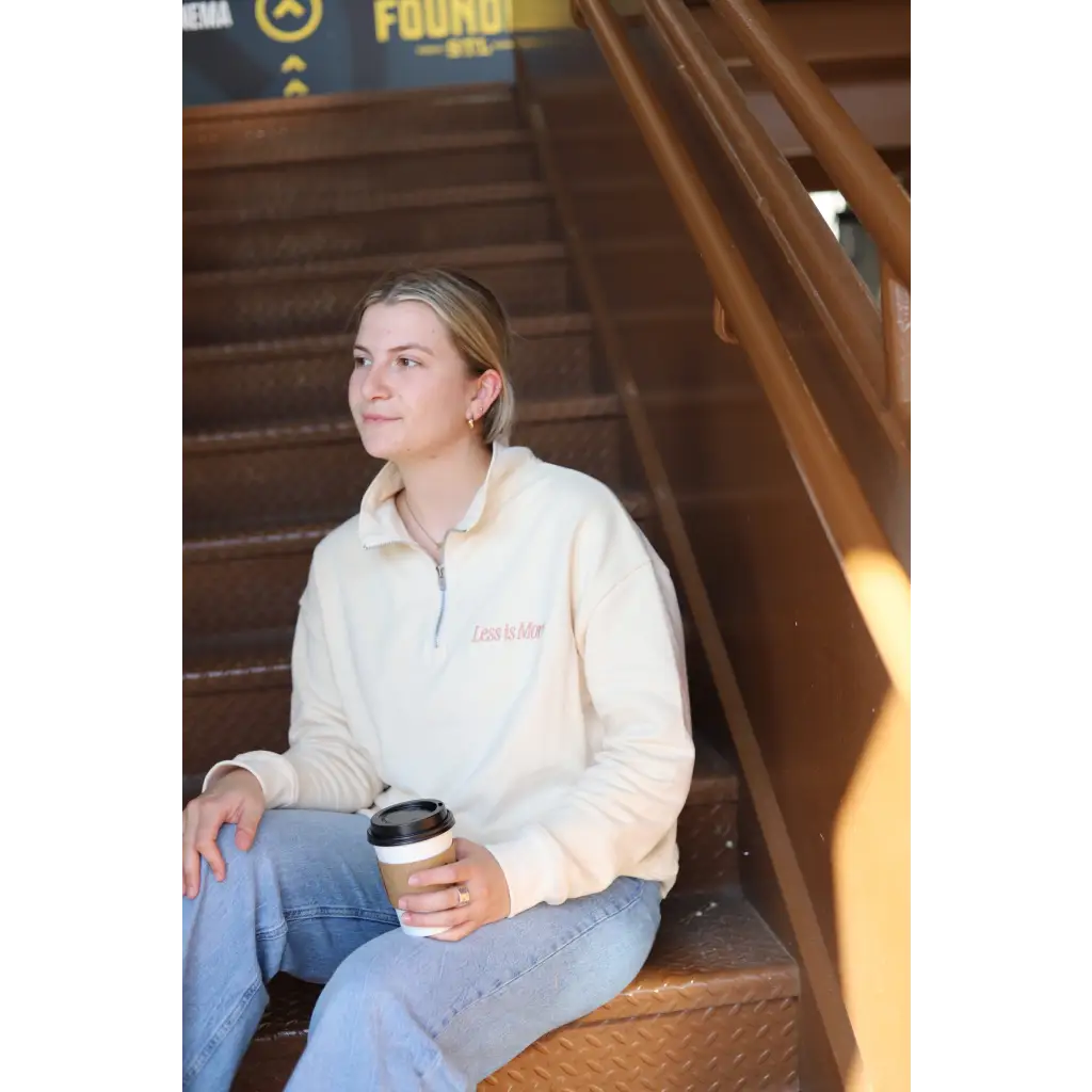 Casual vibe of Cool Cream Embroidered Pullover with jeans and coffee on stairs