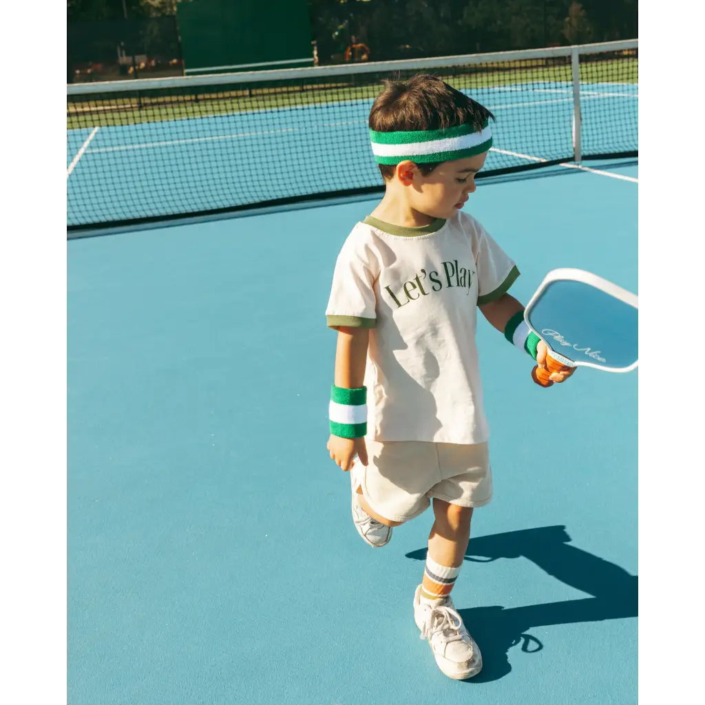 Young tennis player in a white ringer t-shirt enjoying summer fun and adventures