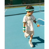 Young tennis player in a white ringer t-shirt enjoying summer fun and adventures