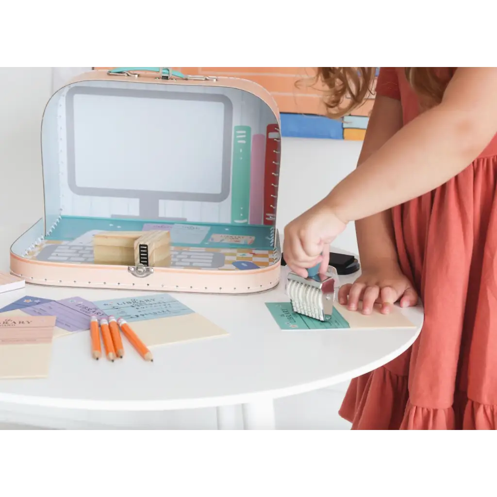 Pink suitcase art supply case with stamps and markers for the Library Play Kit