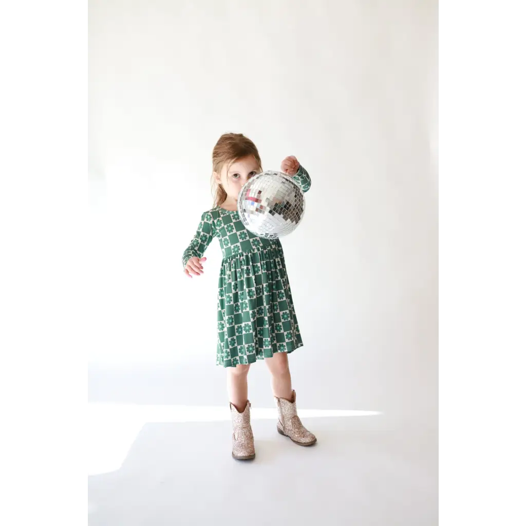 Green floral print Lily Flower Check Long Sleeved Twirl Dress paired with tan ankle boots