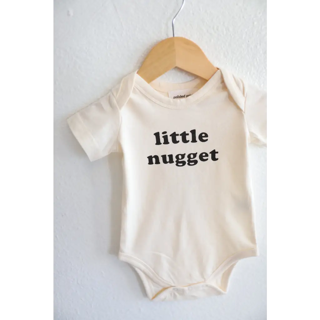 White baby onesie with Little Nugget text, made from soft organic cotton for your nugget