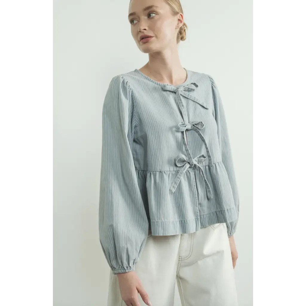 Light blue peplum blouse with sleeve denim bow details and balloon sleeves