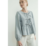 Light blue peplum blouse with sleeve denim bow details and balloon sleeves