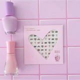 Heart-shaped artwork on pink featuring Ooh La Love Nail stickers with cute emojis