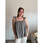 Woman wearing Lucy Gingham Linen Blend Tie Shoulder Tank Top with black and white gingham