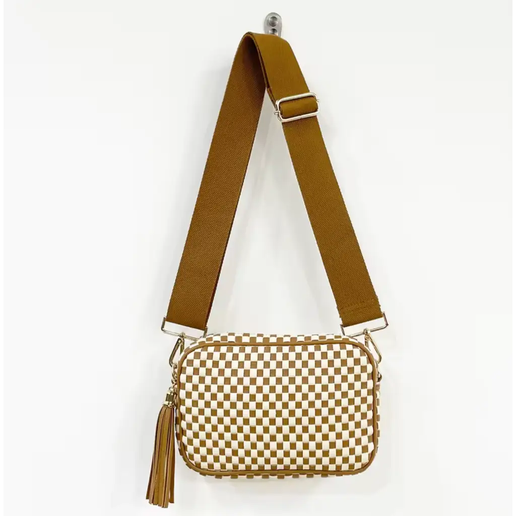 Checkered Lucy Woven Camera Bag with a brown strap and gold tassel for stylish outings