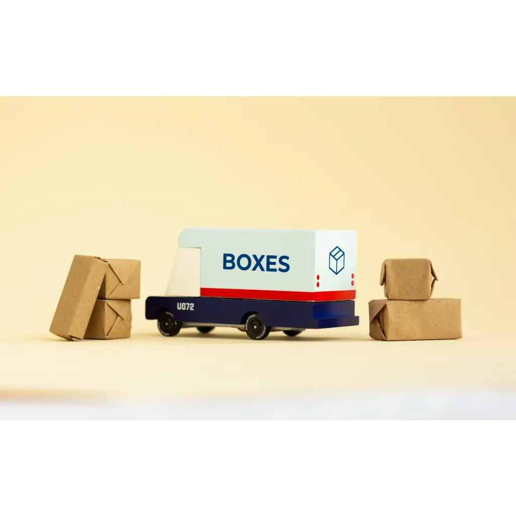 Blue and White Mail Van Toy delivering cardboard packages with boxes around it