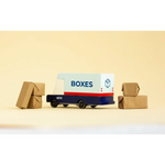 Blue and White Mail Van Toy delivering cardboard packages with boxes around it