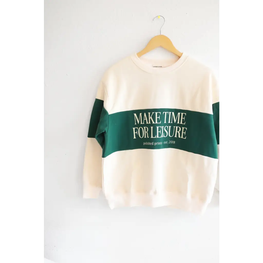 Cream sweatshirt with green stripe saying MAKE TIME FOR LEISURE, perfect for relaxing vibes