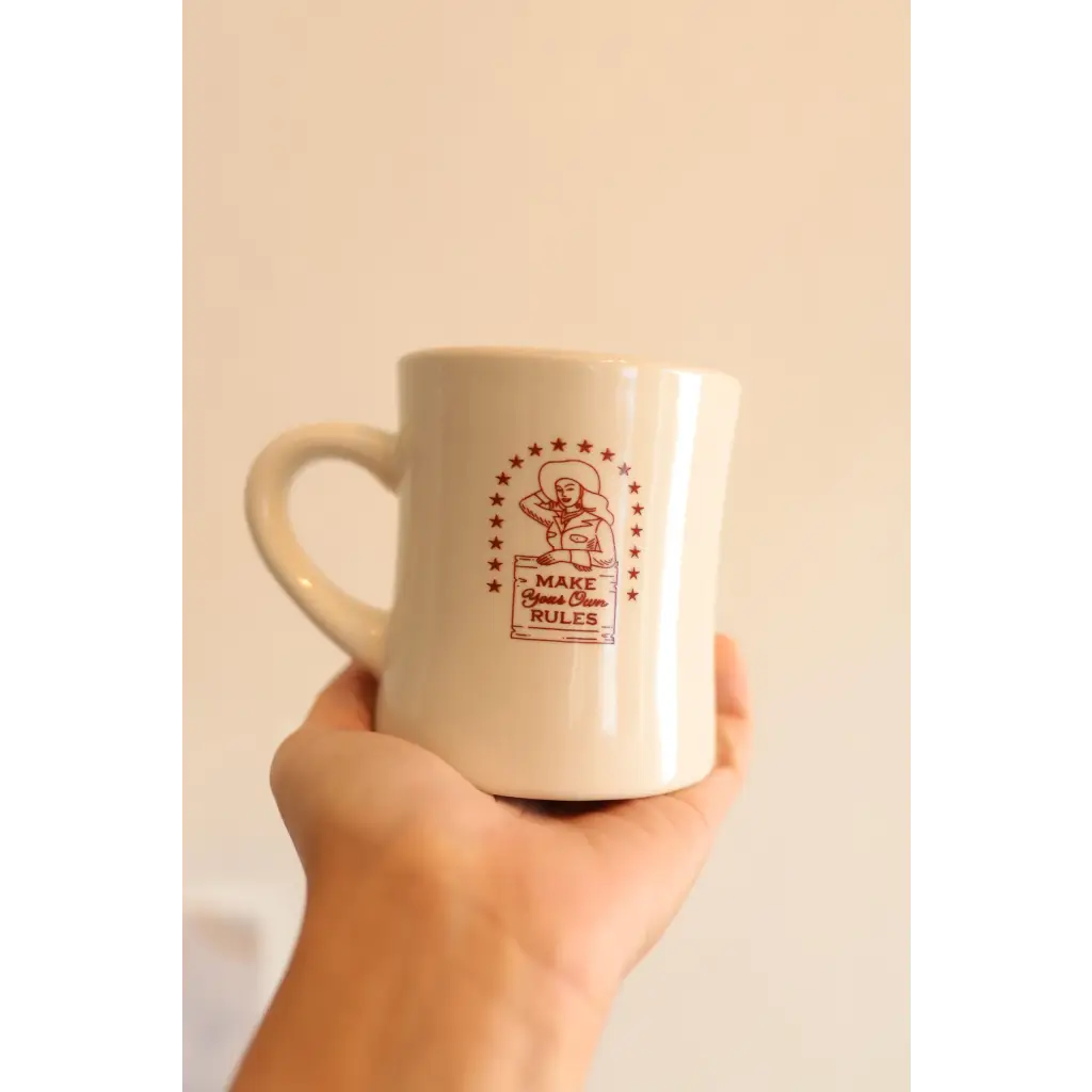 White ceramic mug featuring a red logo for the Peace Signs Camp collection