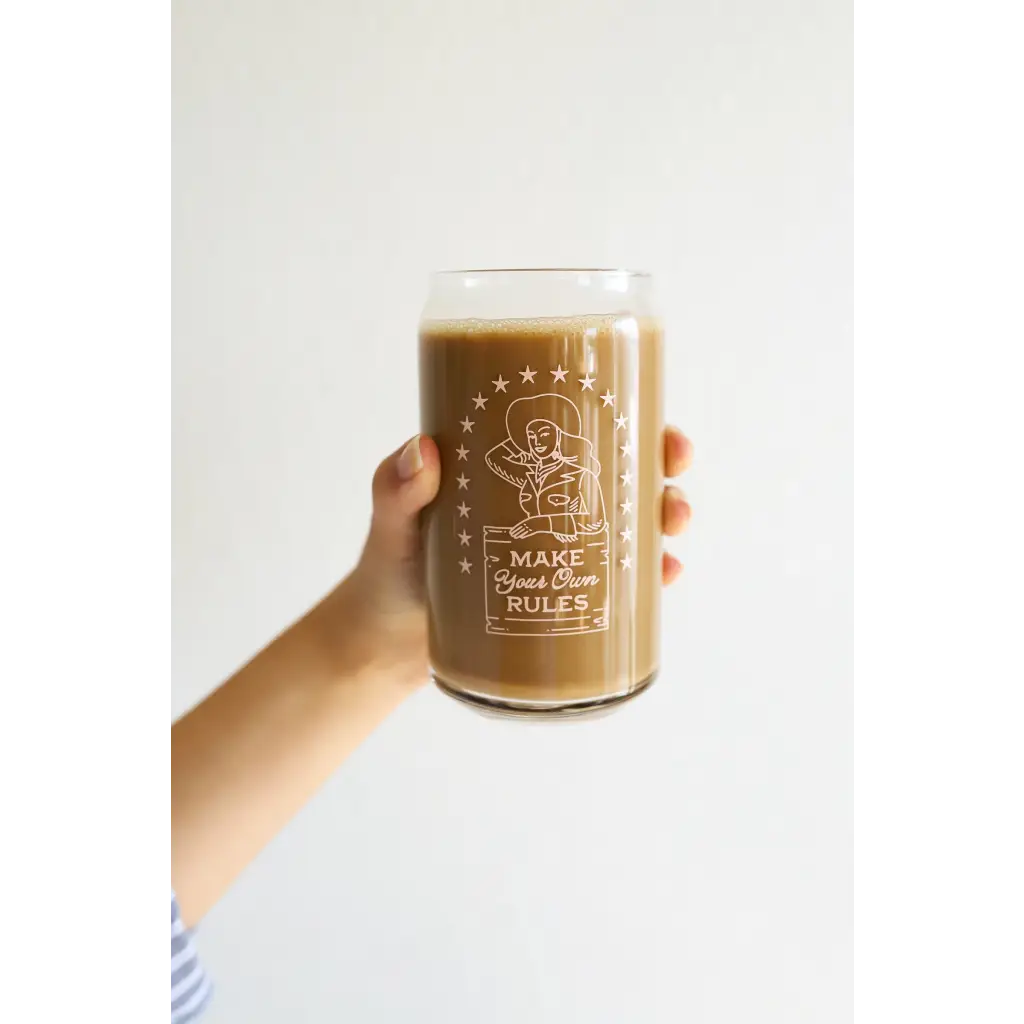 Creamy brown coffee in a decorative rules juice glass with Cow Girl design