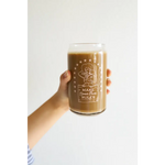 Creamy brown coffee in a decorative rules juice glass with Cow Girl design