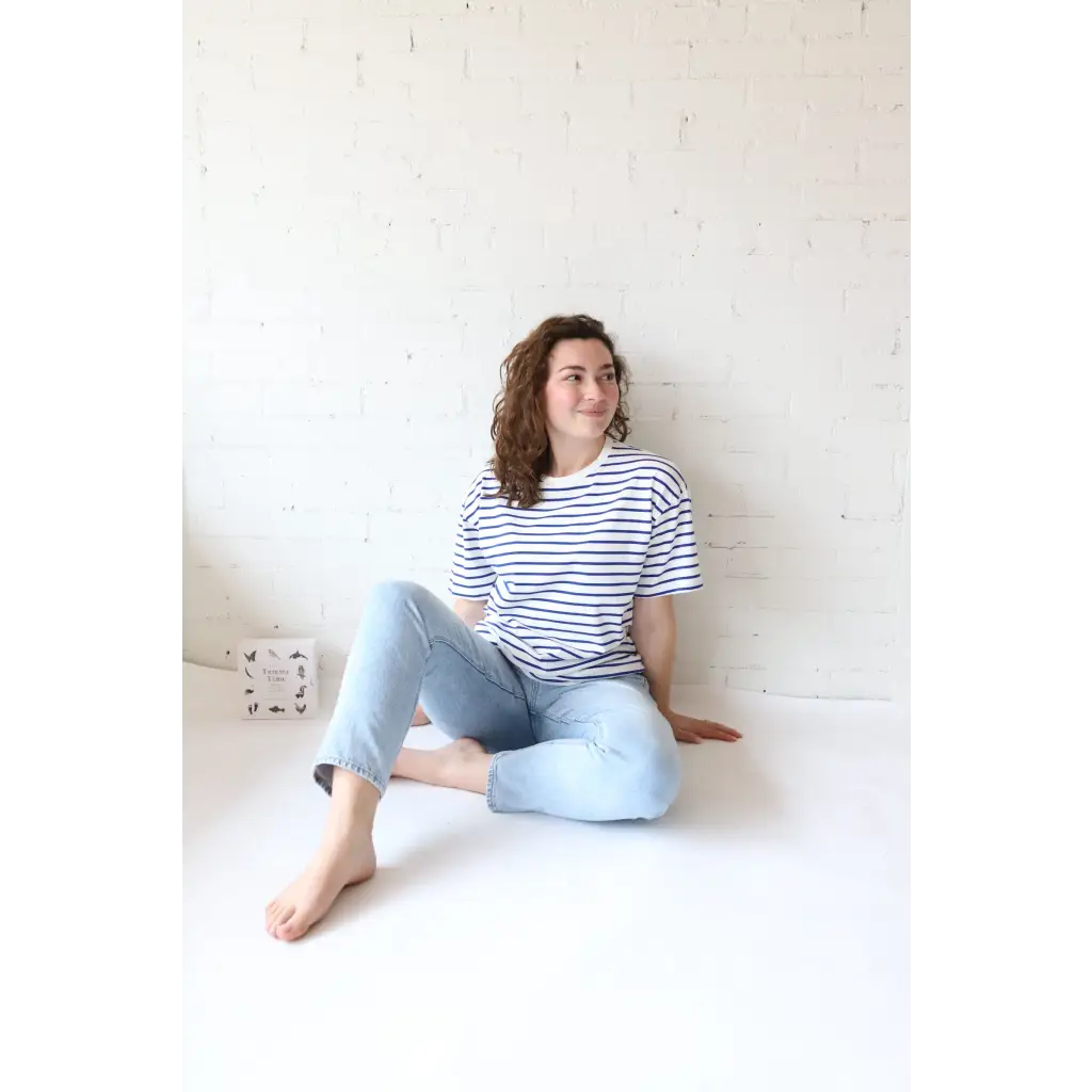 Woman in striped shirt and jeans showcasing Mary Striped Short Sleeve, perfect for stylish womens clothes and moms