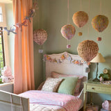 Pastel origami balloon decorations in Meri Meri x Liberty style over bed