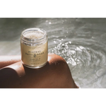 Clear glass jar of mineral bath soak with green tea eucalyptus scent