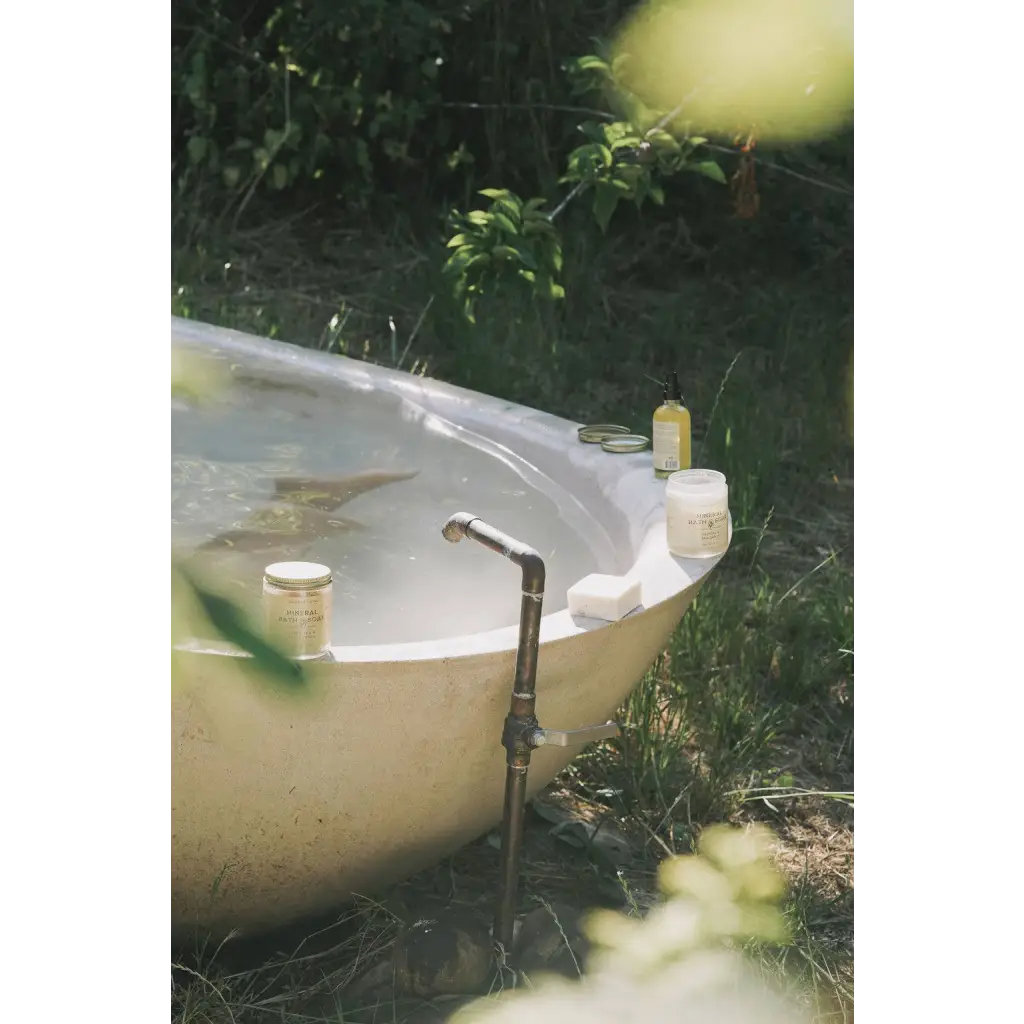 Rustic outdoor bathtub with vintage faucet and Vetiver Bergamot soak