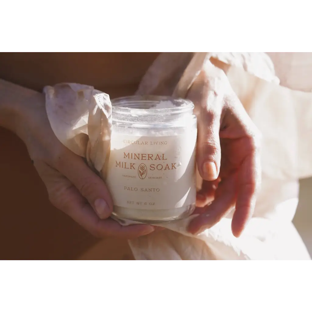 Clear glass jar of Palo Santo mineral milk soak with white label