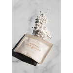 Mineral milk soak sachet with palo santo, white powder spilled from beige pack