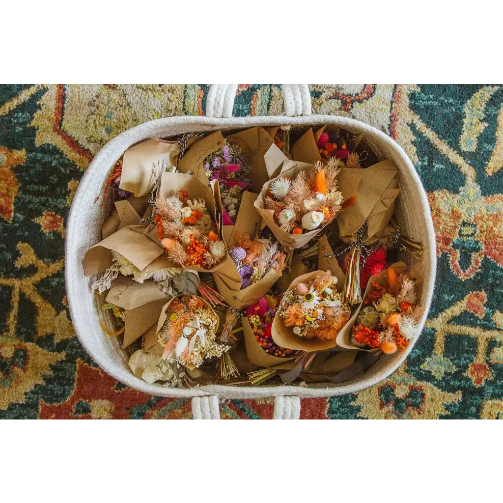 Mini dried flower bouquets in white woven basket