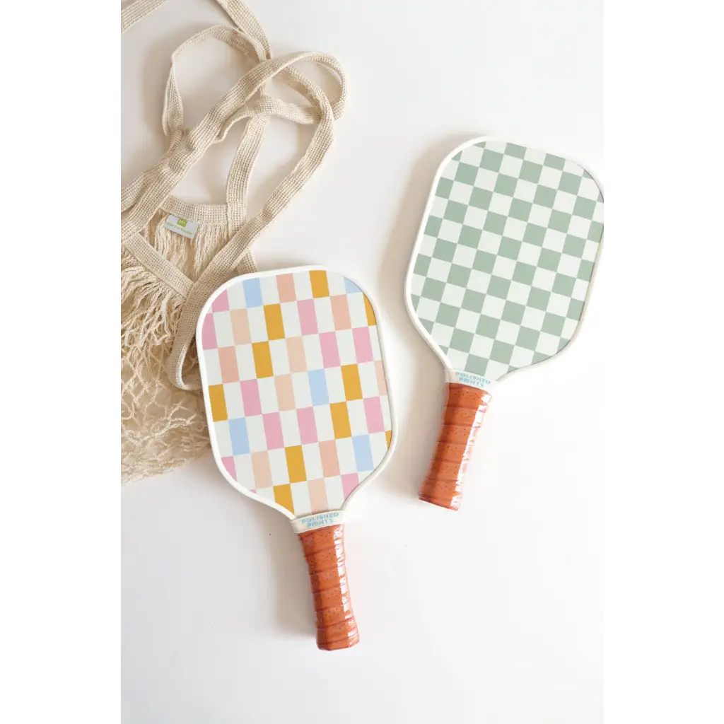 Two checkered paddles with brown handles from the Mini Pickleball Starter Kit