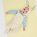 Cute Mint Bunny baby onesie in white overalls, blue checkered shirt, beige hat with gray rabbit ears