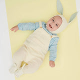 Cute Mint Bunny baby onesie in white overalls, blue checkered shirt, beige hat with gray rabbit ears