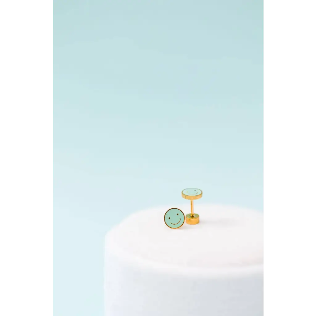 Gold smiley face stud earrings with green enamel and flat screw-on backs