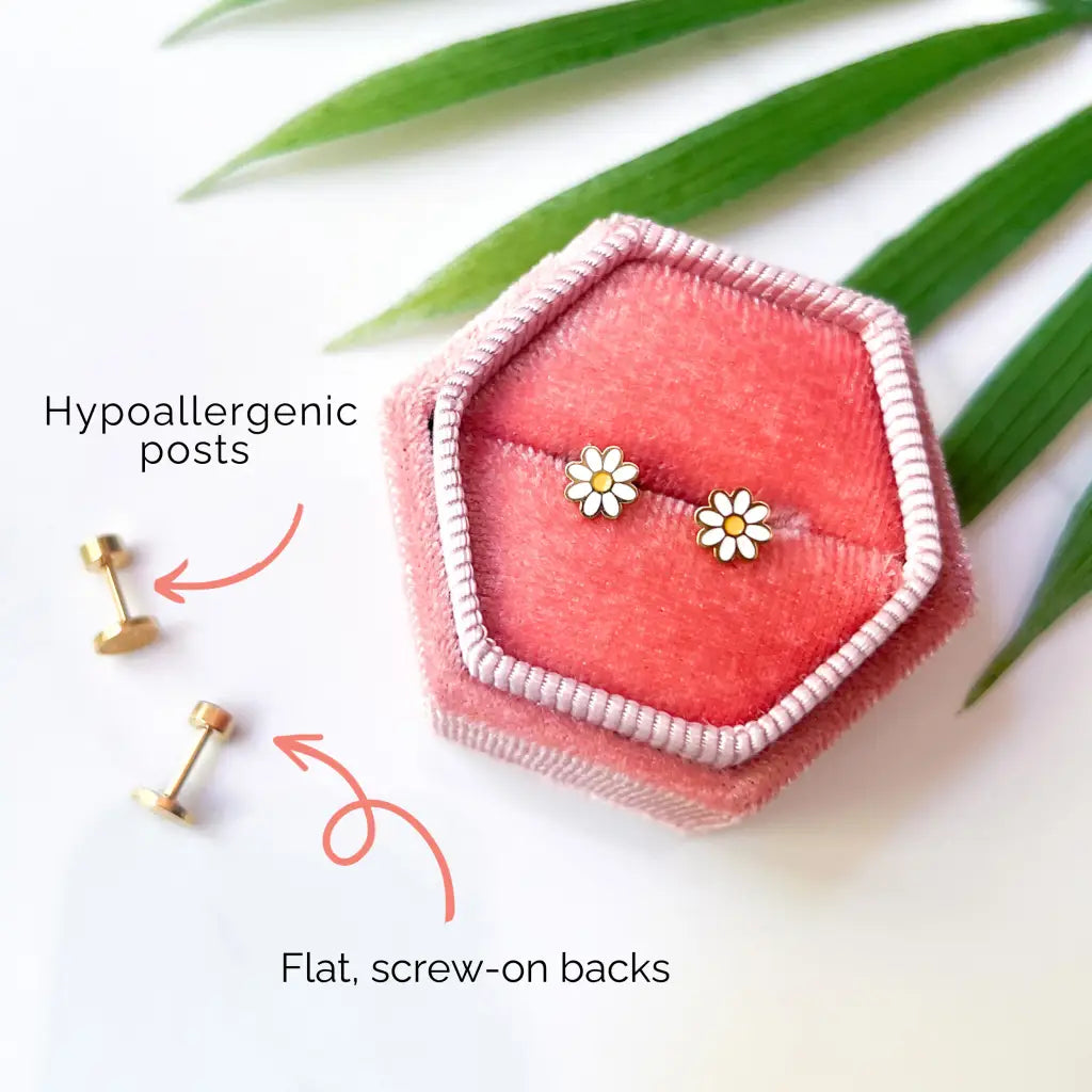 Gold daisy stud earrings with flat screw-on backs in pink box