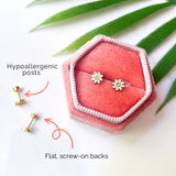 Gold daisy stud earrings with flat screw-on backs in pink box