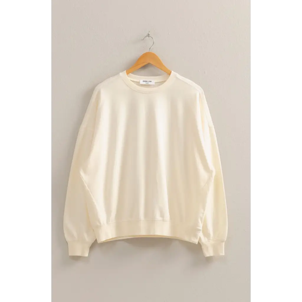 Cream-colored crewneck sweatshirt, perfect addition to stylish womens clothes collection