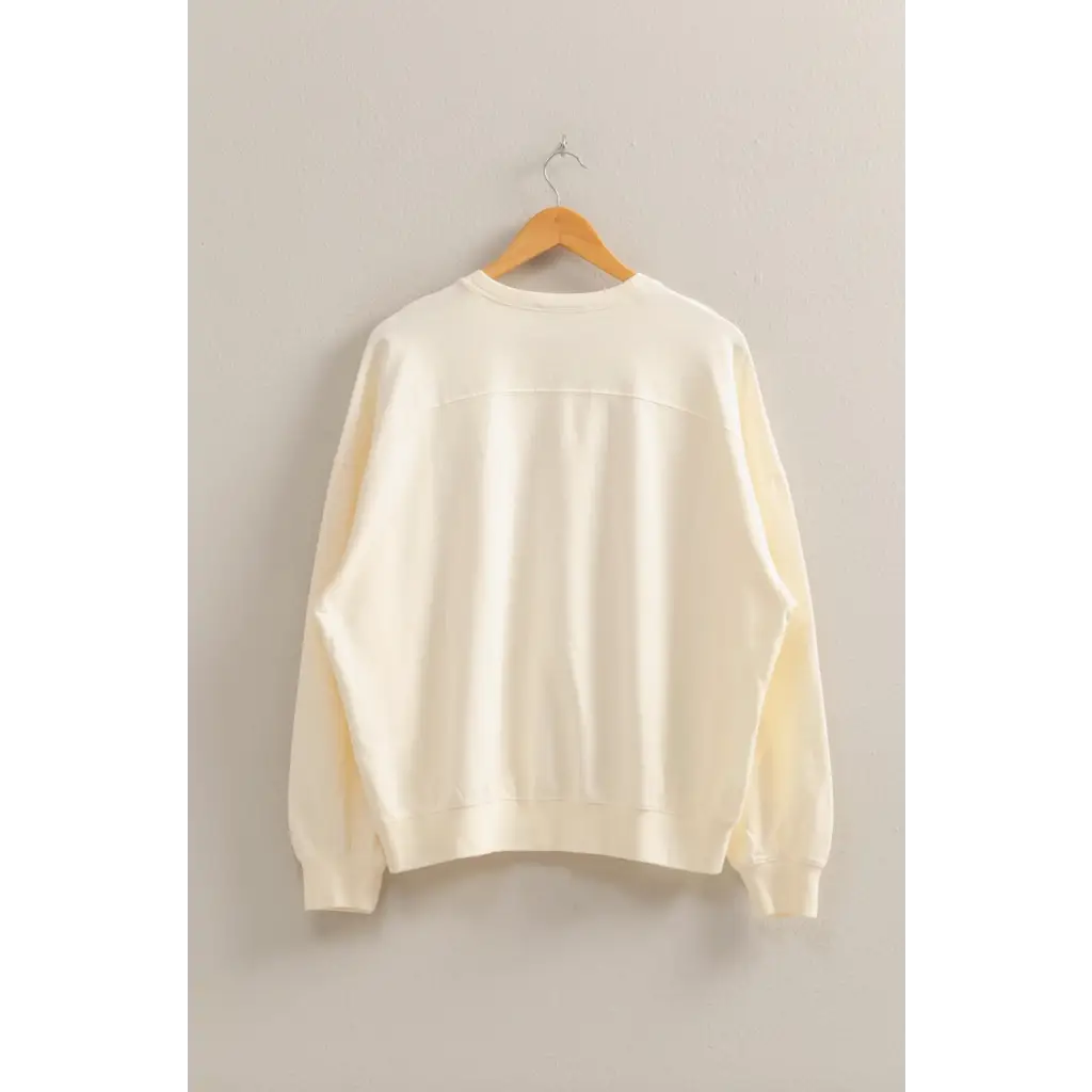 Cream-colored Molly Warm Long Sleeve French Terry Sweatshirt on hanger, stylish womens clothes