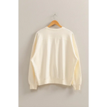 Cream-colored Molly Warm Long Sleeve French Terry Sweatshirt on hanger, stylish womens clothes