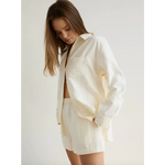 Woman wearing Monica Cream Button Up Shirt with white linen shorts, stylish womens clothes