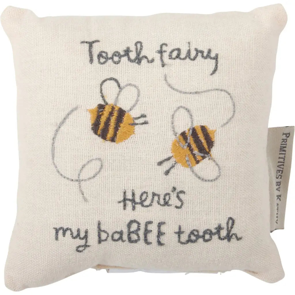 Cream-colored linen tooth fairy pillow with embroidered bees and babee tooth text