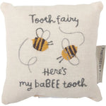 Cream-colored linen tooth fairy pillow with embroidered bees and babee tooth text