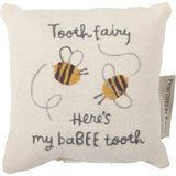Cream-colored linen tooth fairy pillow with embroidered bees and babee tooth text