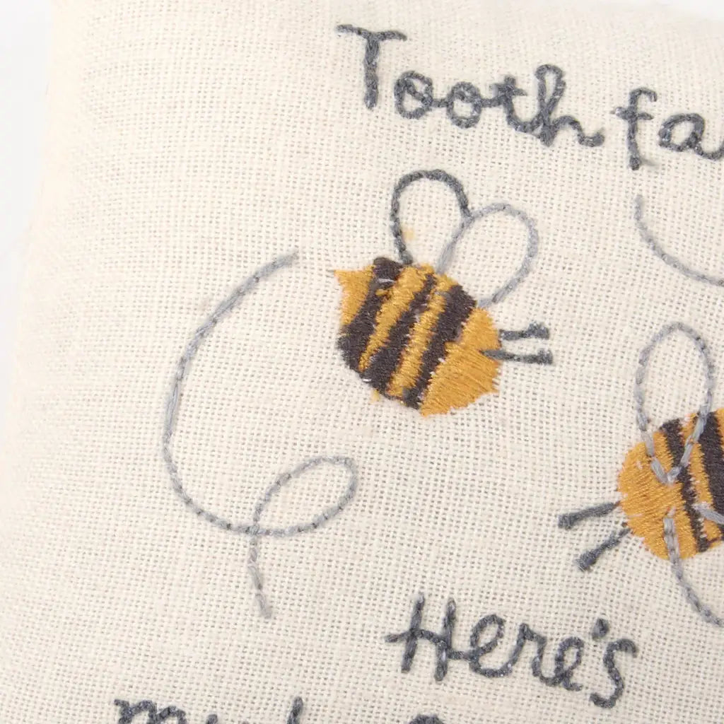Cream-colored tooth fairy pillow with embroidered bees and My Babe-bee text