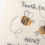 Cream-colored tooth fairy pillow with embroidered bees and My Babe-bee text