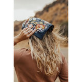 Navy blue bandana with orange floral pattern on blonde hair, perfect for adding style