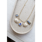 Gold chain necklace with clay charms like shells, sailboat, fish, and good luck symbols