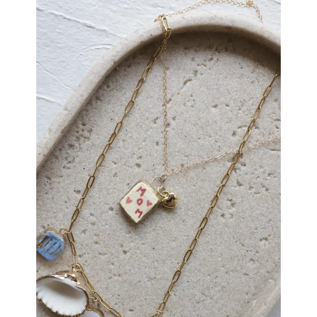 Gold layering necklaces with MOM pendant, heart, seashell, and blue clay charms