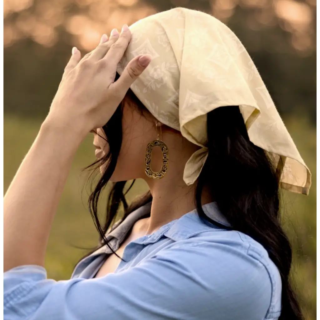 Person in light blue shirt and cream head covering showcasing Elena Bandana with Polished Prints