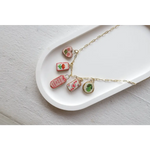 Gold chain necklace with five embroidered clay seaside charms from No 7 Its Working Out