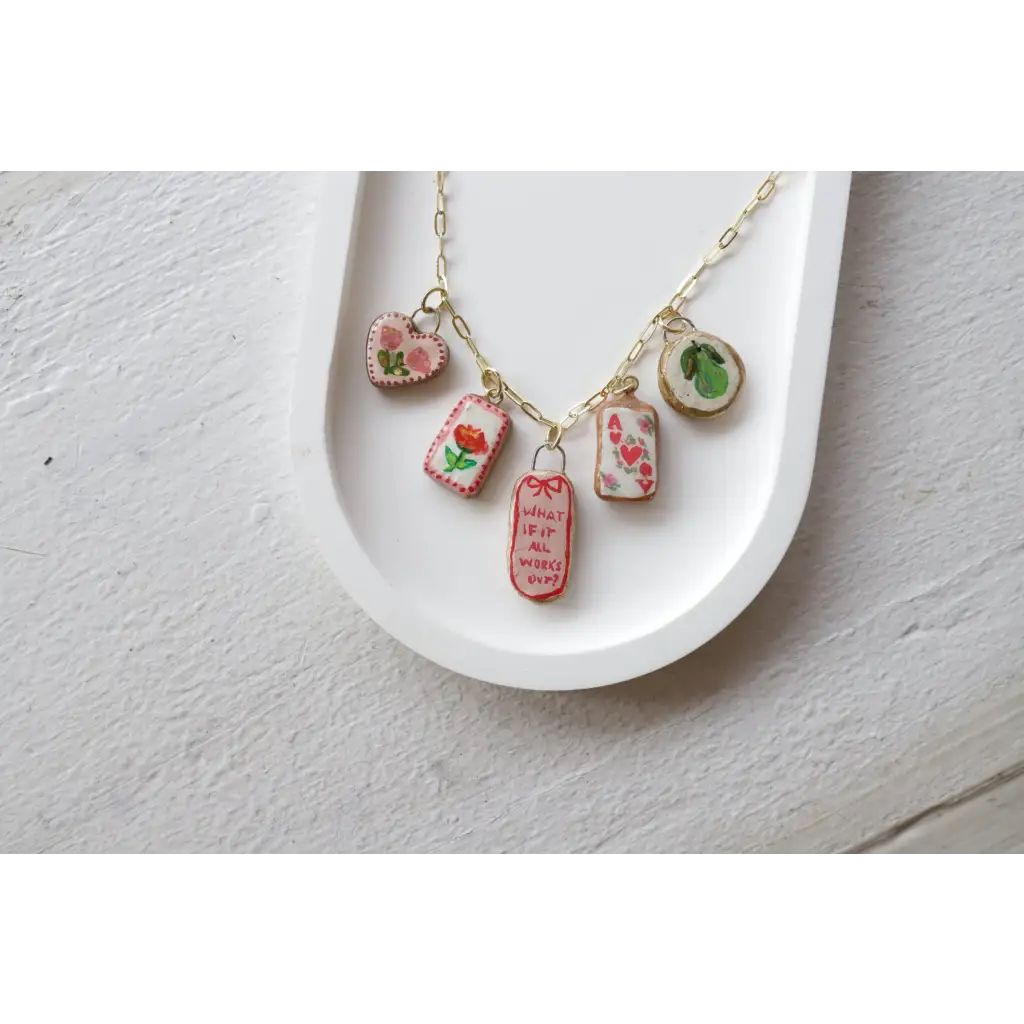 Gold chain necklace with five unique clay seaside charms for the No. 7 Its Working Out collection