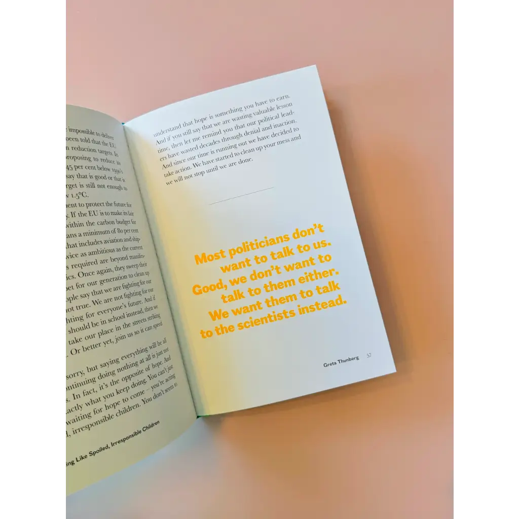 Open book displaying yellow text from Greta Thunberg’s speeches made in polished prints