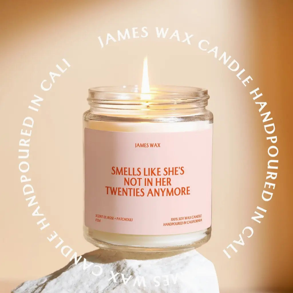 Lit Twenties Birthday Candle in a glass jar with a funny label about aging