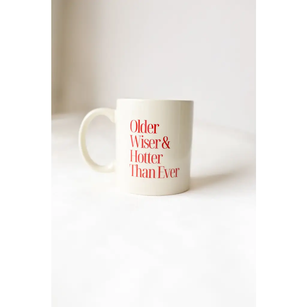 Funny cream mug with red ink saying Older Wiser Hotter Than Ever, perfect gift!