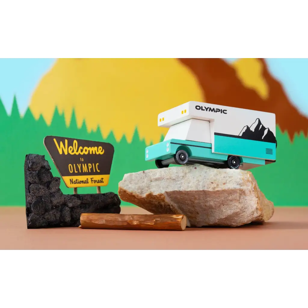 Turquoise Olympic RV Toy car made of solid beech wood near Olympic National Park sign