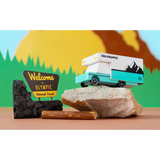 Turquoise Olympic RV Toy car made of solid beech wood near Olympic National Park sign